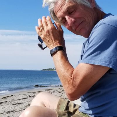 Dad sitting by the beach