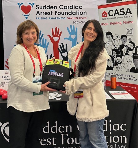 Mary Newman presents ZOLL AED donated by CoroMed to Amy Sauro